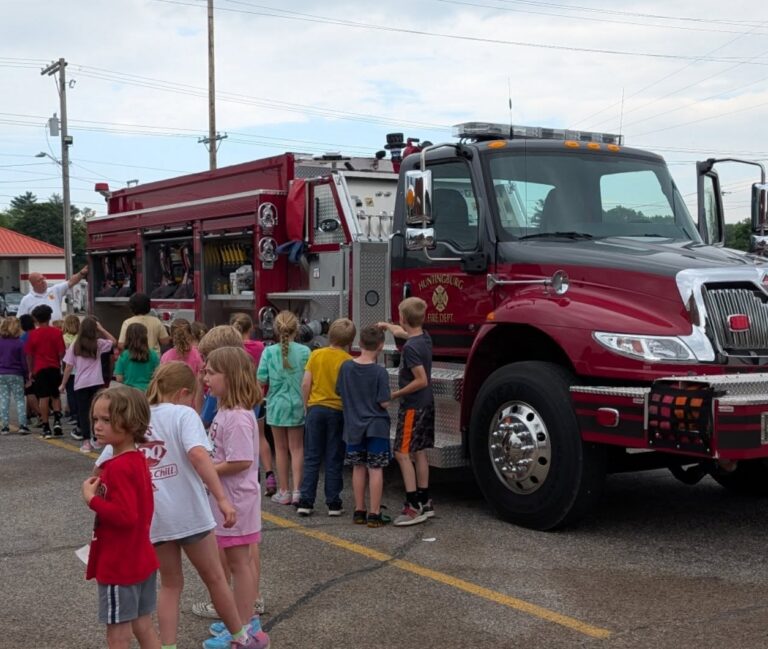 Children looking at a firetruck.