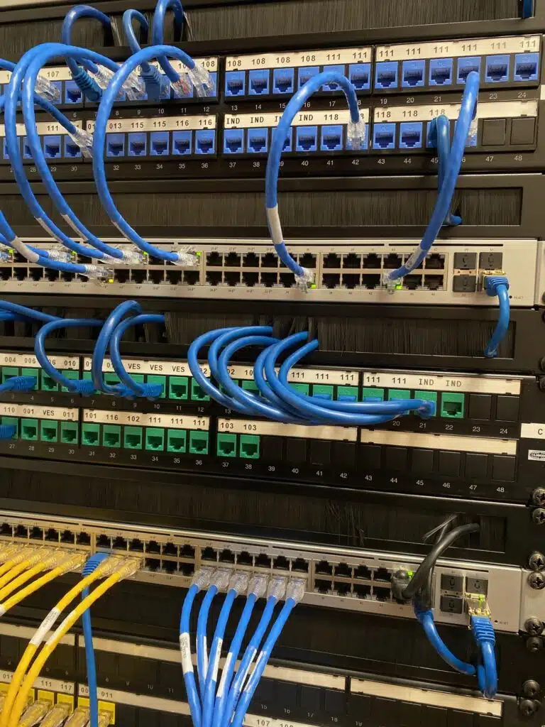 Blue and yellow wires attached to back of computer server.