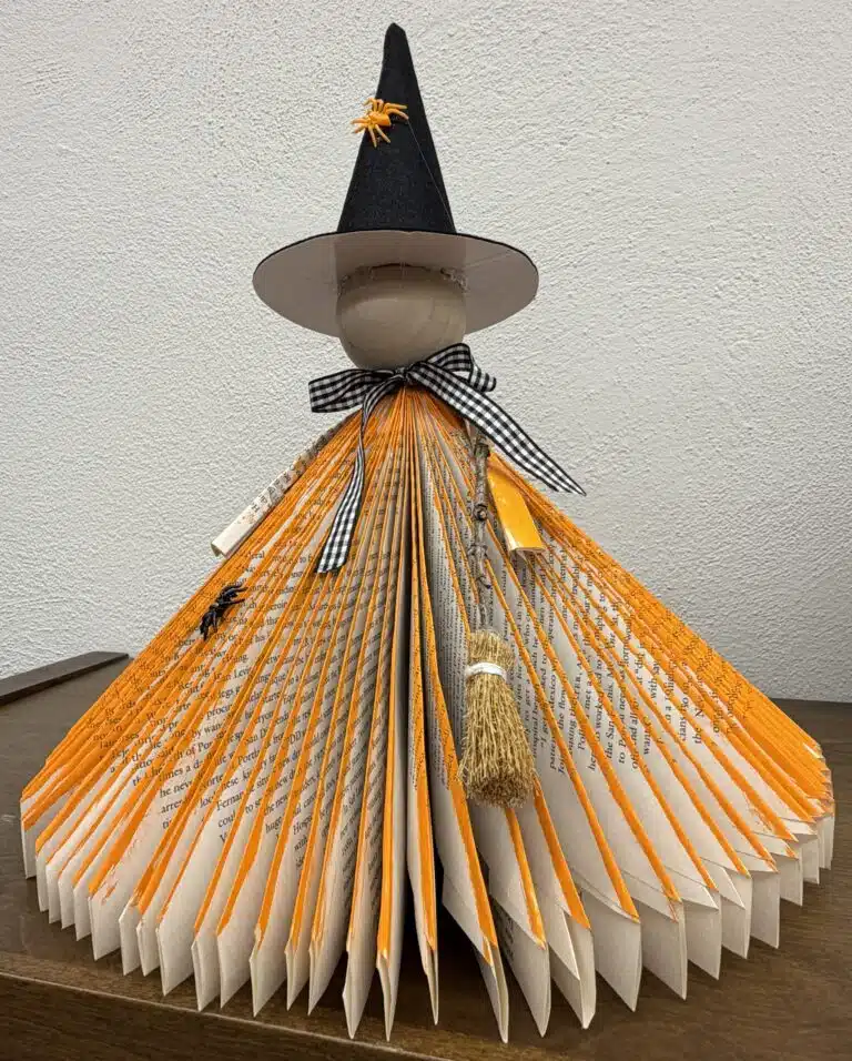 Rustic looking Halloween witch decoration made from the folded pages of a book.