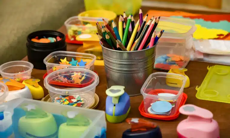 Containers of colored pencils, stickers, and other craft supplies.