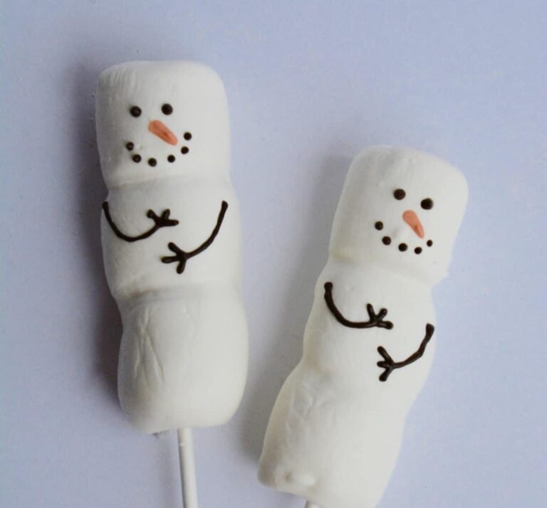 Smiling snowmen made from marshmallows.