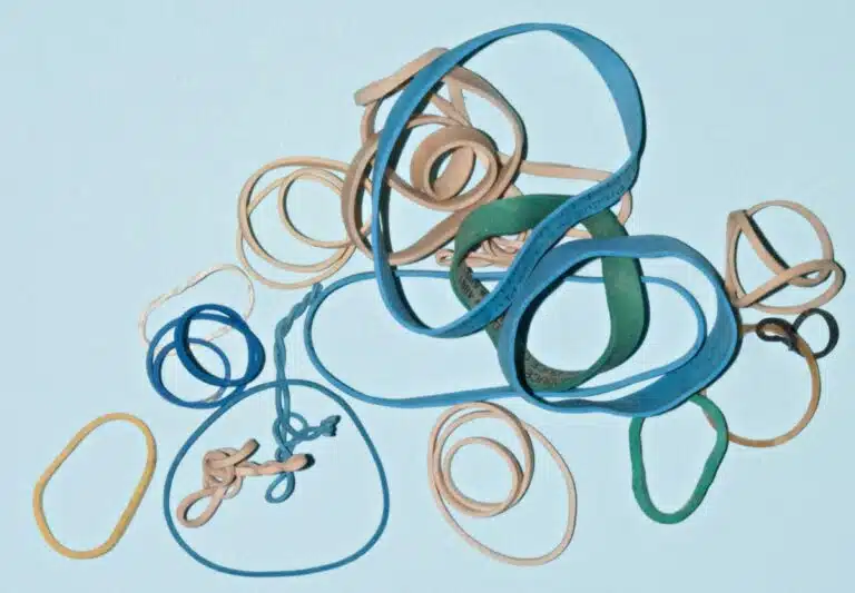Cluster of green, blue and tan rubber bands.