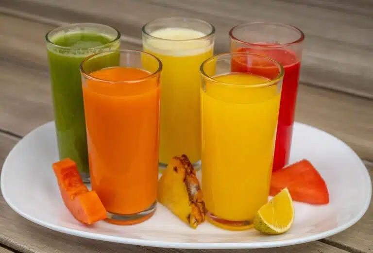 Tall glasses of healthy drinks made from fruits and vegetables.