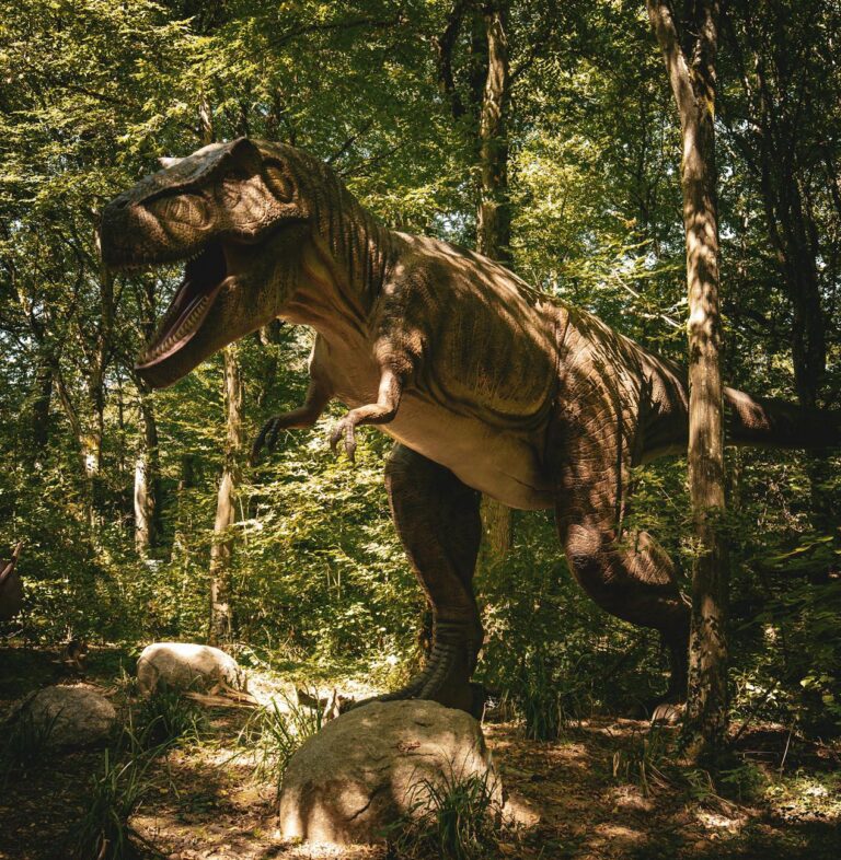 Big tyrannosaurus rex dinosaur in a shadowy green forest.