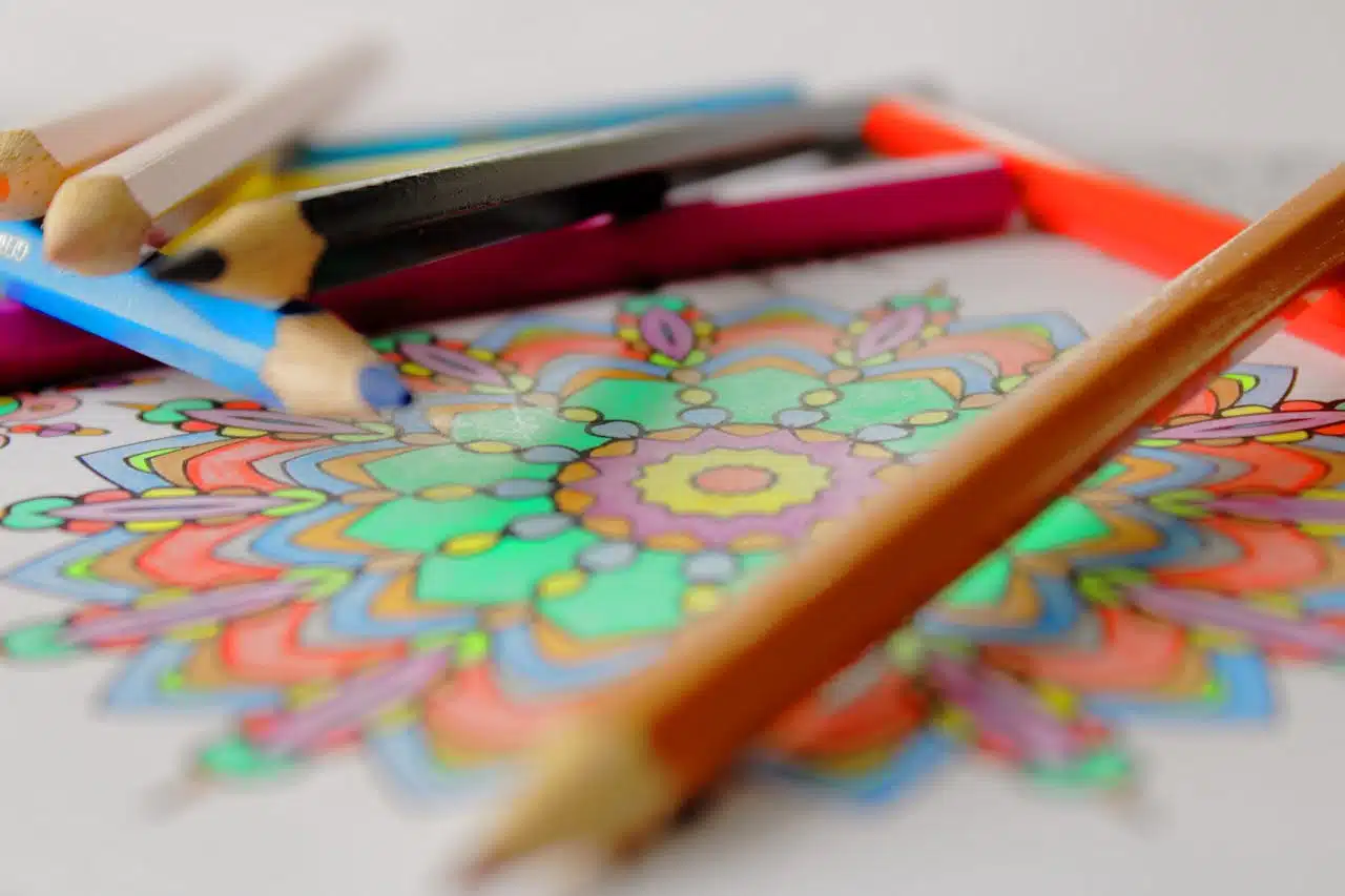 Adult coloring page with colored pencils.