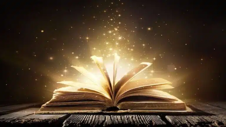 Open book with glowing golden light bursting from the pages.