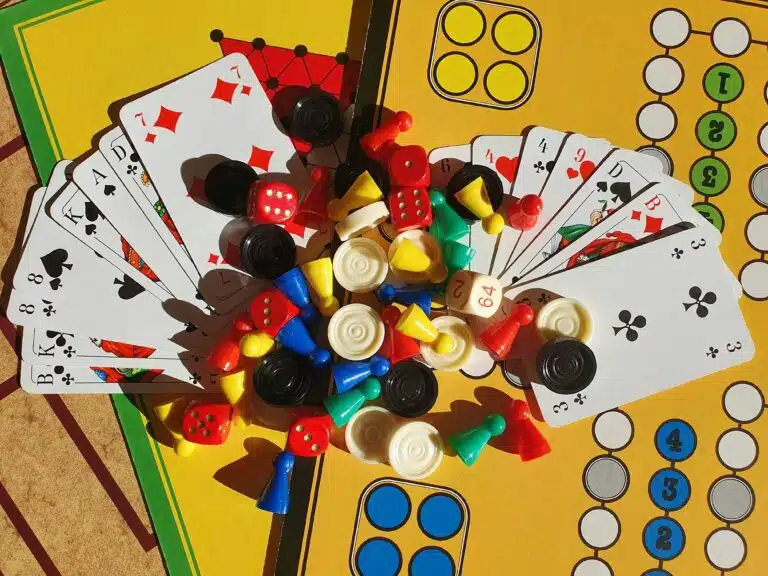 Board game pieces, dice, and playing cards.