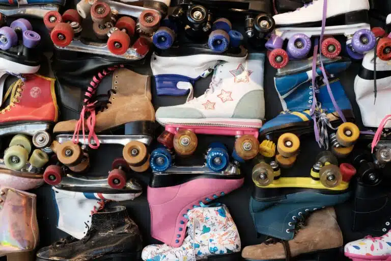 A pile of colorful assorted roller skates.